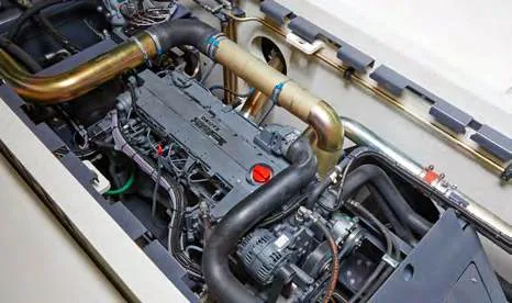 CHALLENGER 550 — diesel engine bay with exhaust piping and alternator
