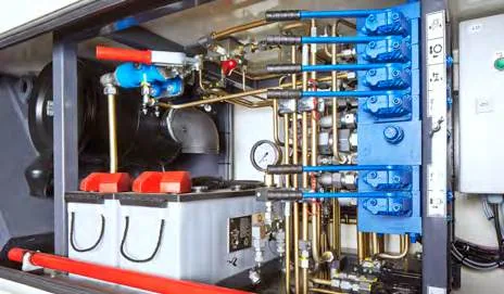CHALLENGER 550 — hydraulic valve bank, pressure gauge and batteries in the service bay