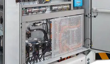 CHAMP 140e — opened cabinet with control electronics behind a perforated screen